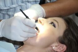 dentist doing dental implant on a Australian lady